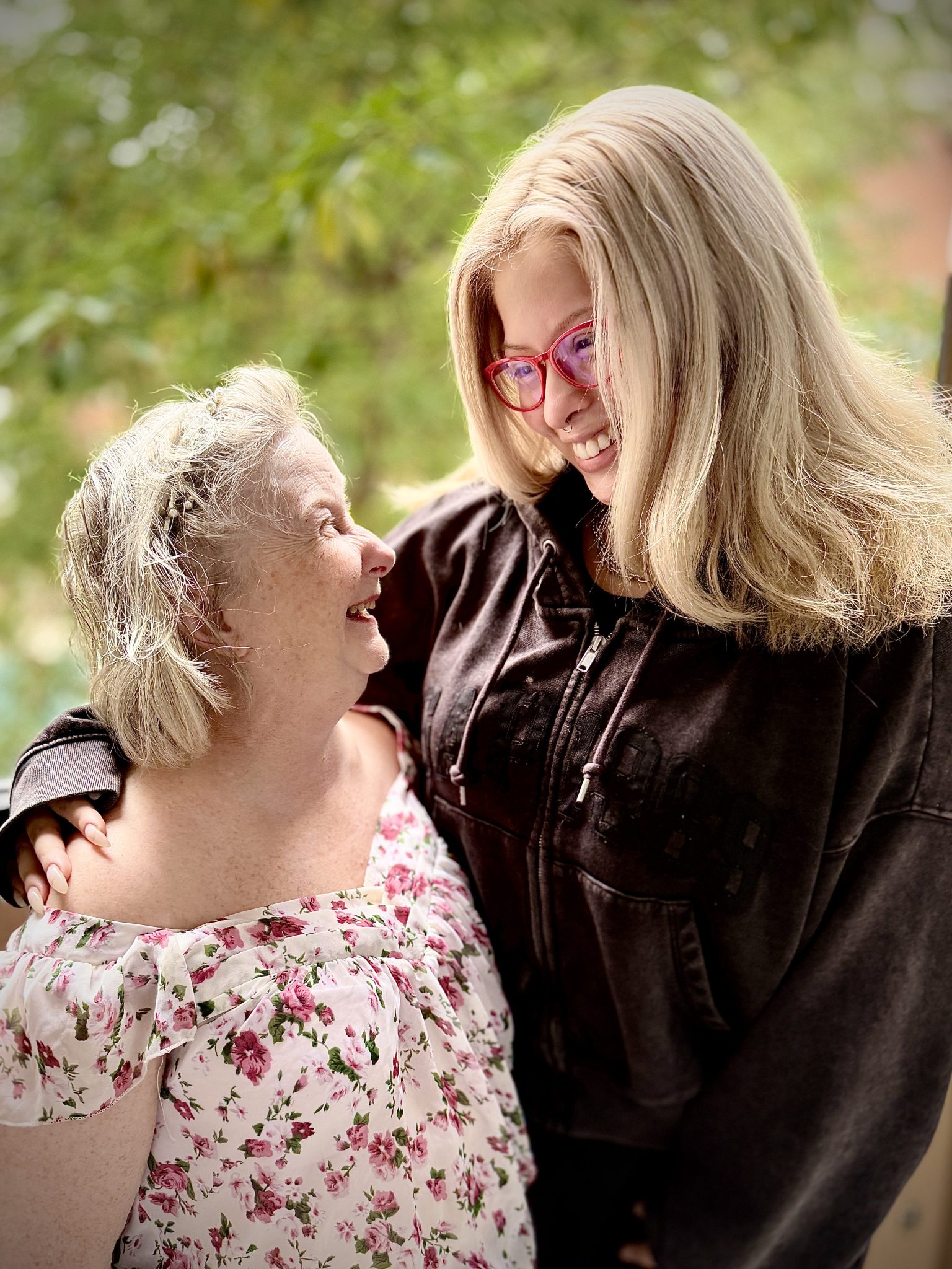 Two women with their arms around each other looking at each other. MaryJo Wybierala. and her Jubilee DSP Jessica Giroux