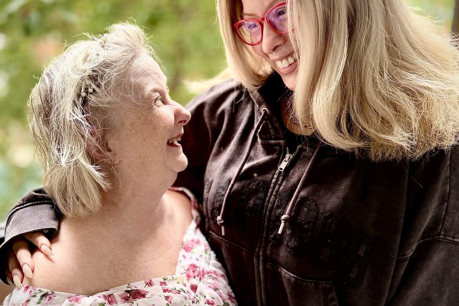 Two women with their arms around each other looking at each other. MaryJo Wybierala. and her Jubilee DSP Jessica Giroux