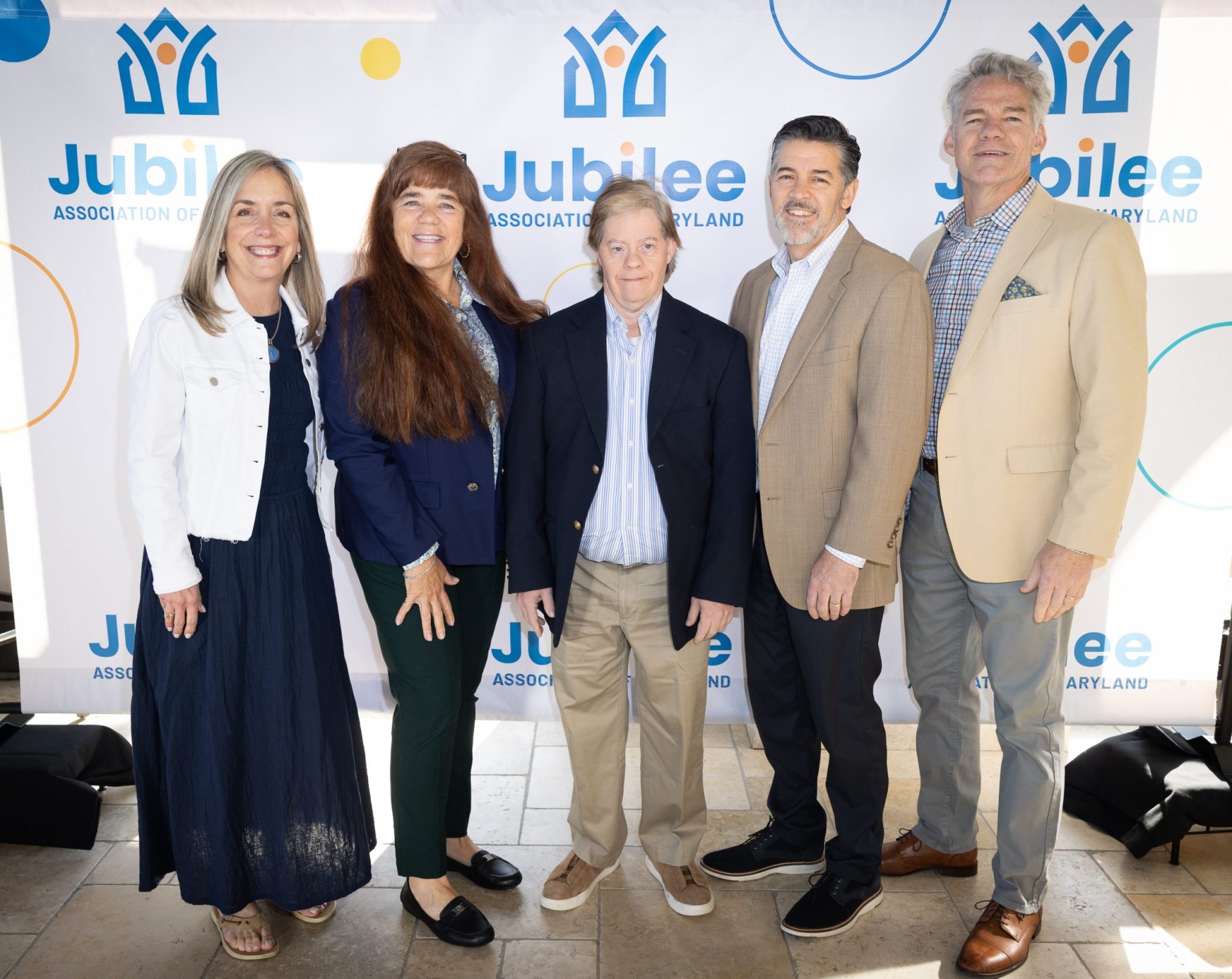 The Flaherty family attend Jubilee's 2026 Champions of Inclusion fundraiser. 
[a picture of 2 women and 3 men posing in front of a backdrop that says Jubilee Association of Maryland]