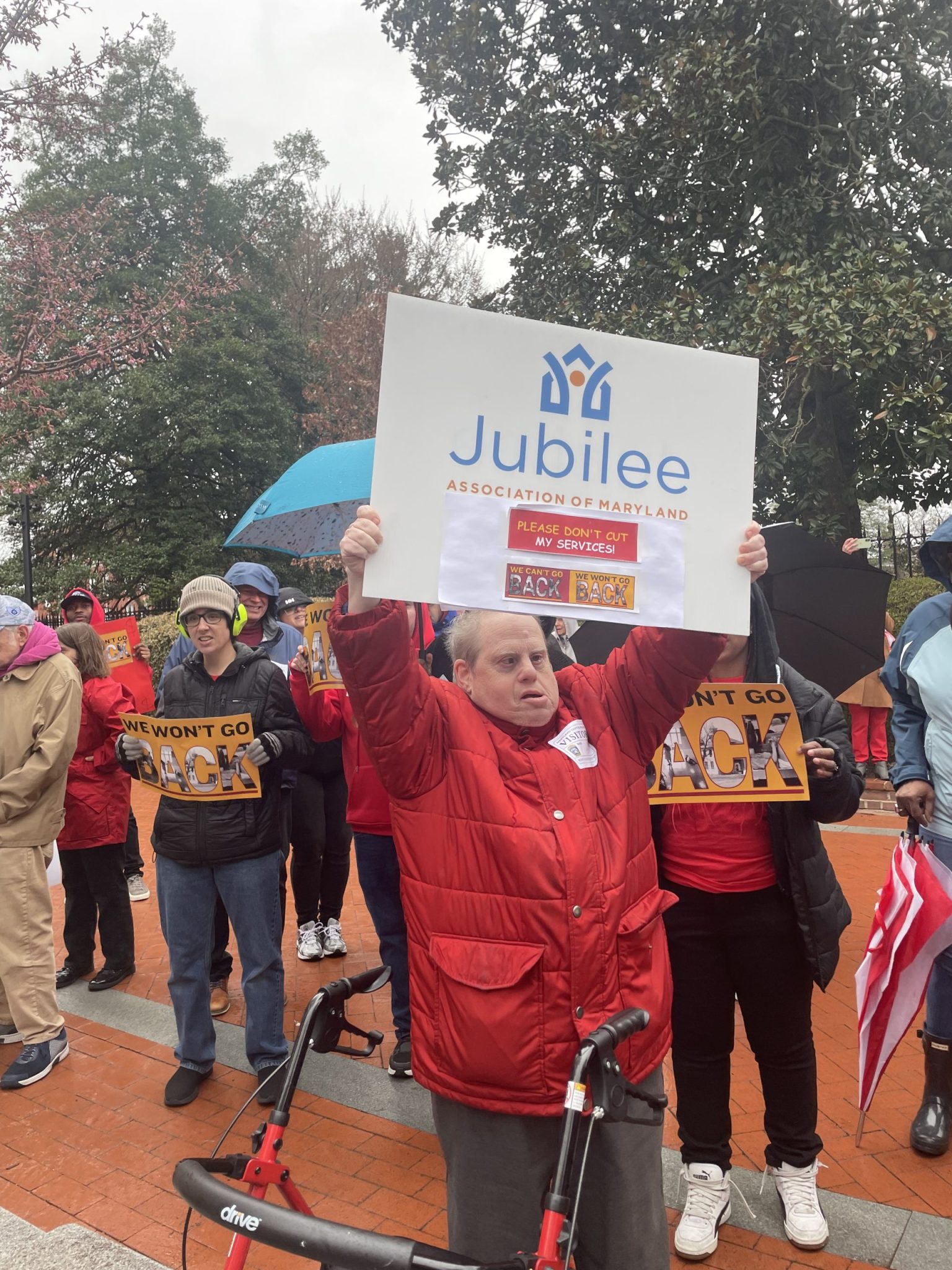 A man holds up a sign at a rally