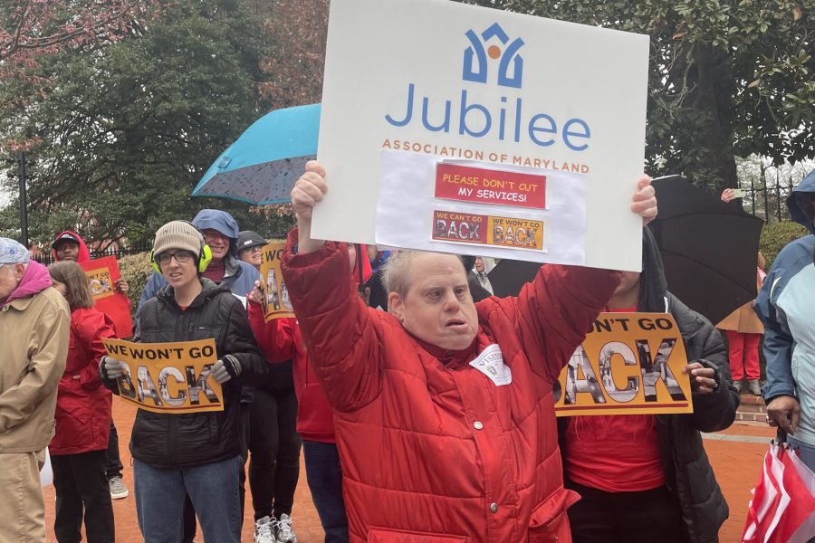 A man holds up a sign at a rally