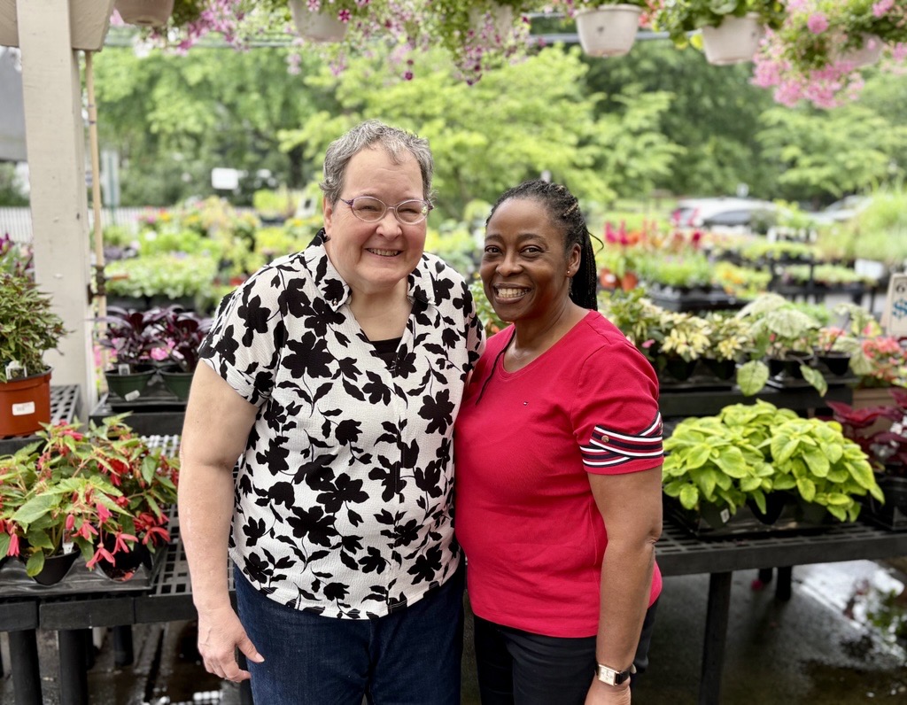Donna Zimmerlin and Muriel Menzene (left to right) enjoy a day out in Kensington. They stand with their arms around each other at Johnson's Garden Center admiring the flowers for sale.