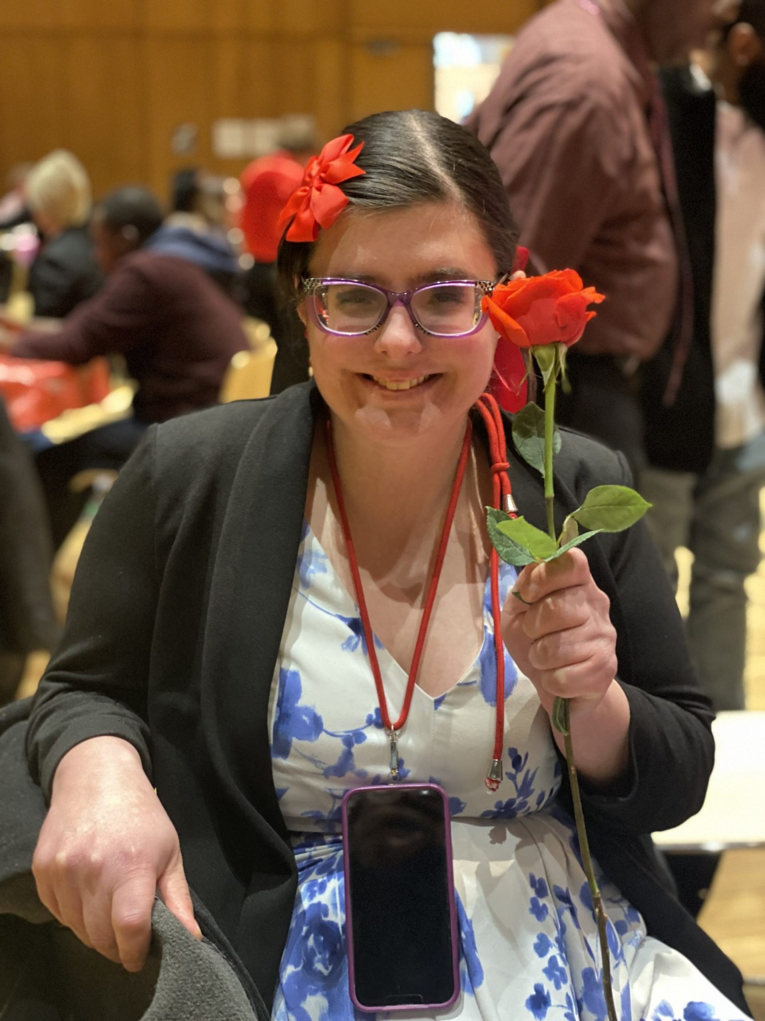 A young woman holds up a red rose [Kitty at Valentine's Day party]