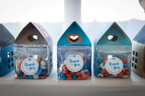 Hand painted candy boxes in the shape of homes with stickers that say Thank You with the Jubilee logo