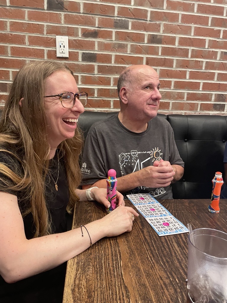 Two people play Bingo together at an event